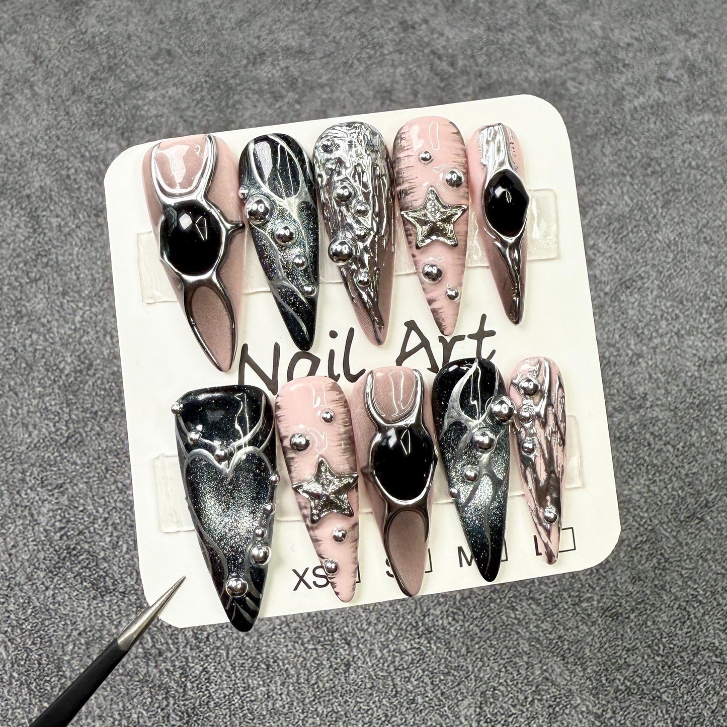 Metallic hand-painted nail art with long pointed nails, 3D effect, sweet and spicy style, cat-eye design, wearable nails, all handcrafted.