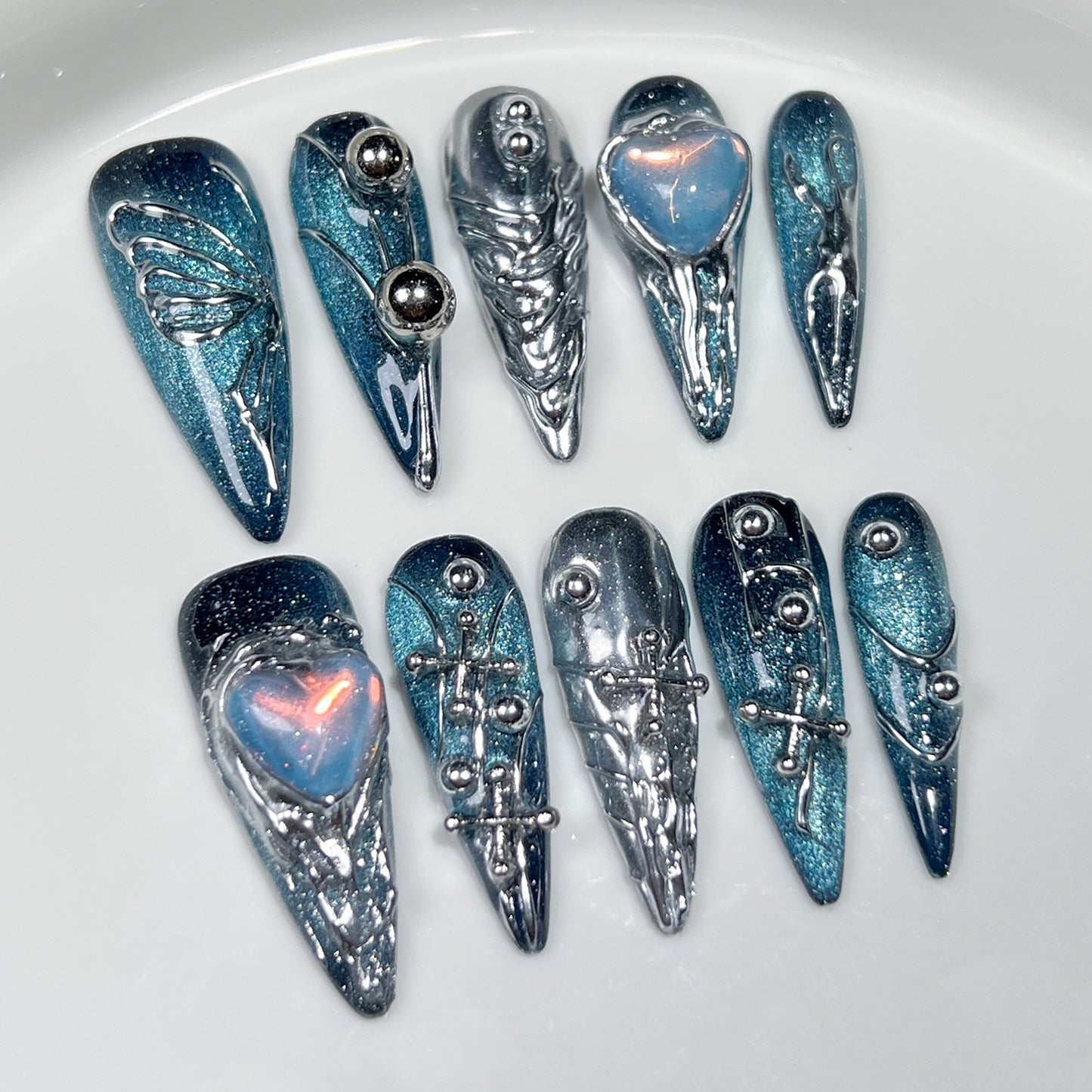 Handmade nail art stickers featuring a space galaxy design with hand-painted butterflies. These are long pointed European-style finished nail tips for wearing.