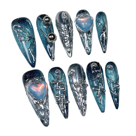 Handmade nail art stickers featuring a space galaxy design with hand-painted butterflies. These are long pointed European-style finished nail tips for wearing.